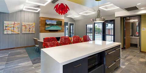 Community Room with seating, a full kitchen, and lounge chairs at Eden Commons in Eden Prairie, MN 55344