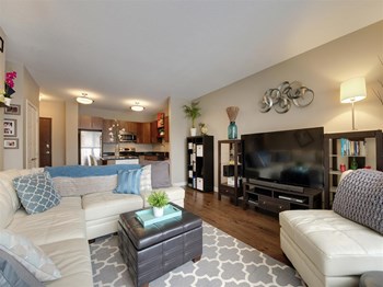 Living Room Be @ Axon Green Apartment Living Room with Open-Concept sight line into Kitchen - Photo Gallery 4