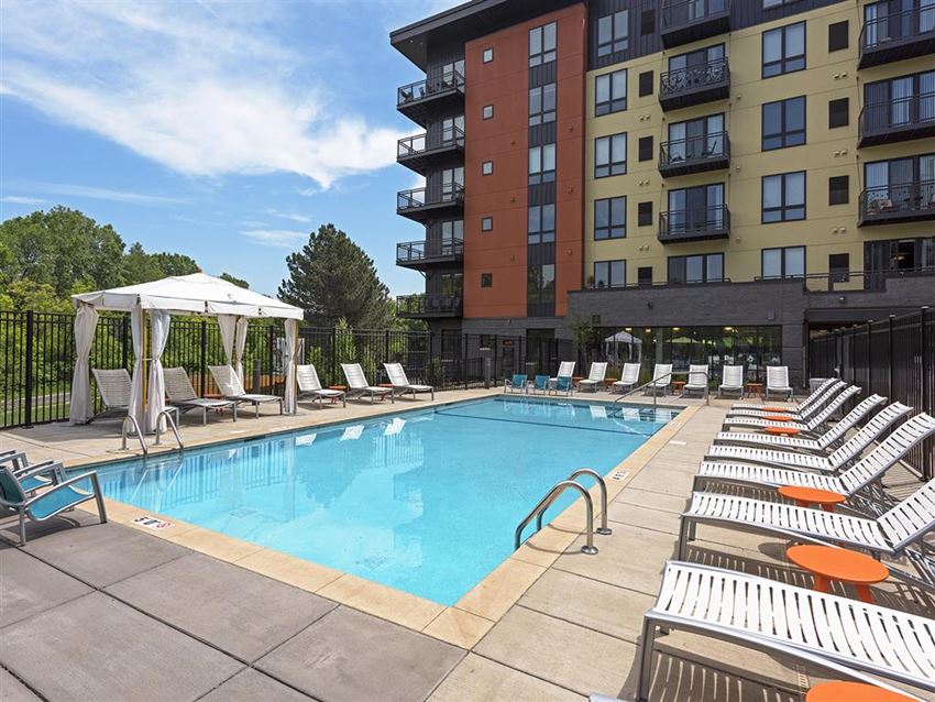 Pool Be @ Axon Green Blue Pool with Poolside Chairs and Cabana