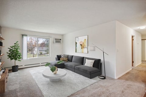 a living room with a grey couch and a white coffee table