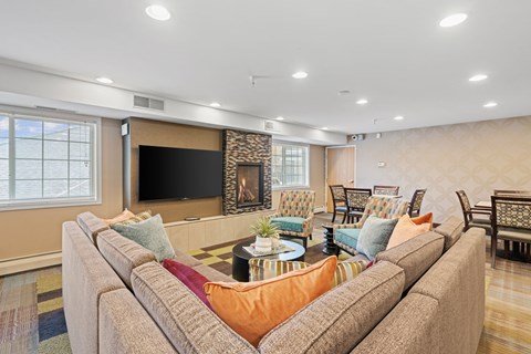A living room with a large couch and a flat screen TV.