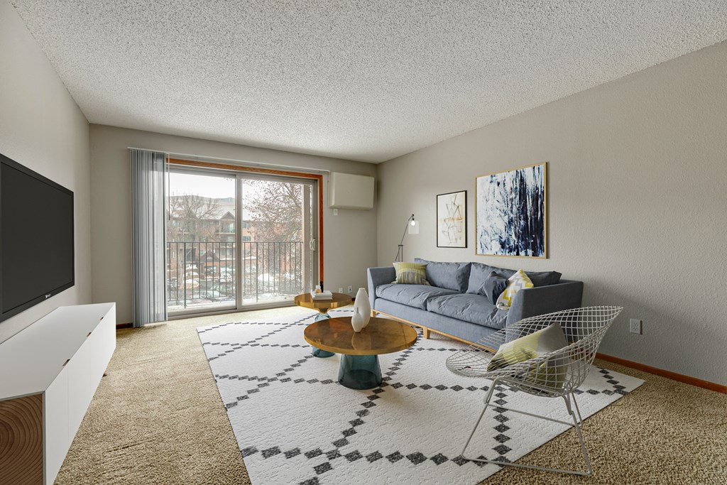 a spacious living room with a sliding glass door leading to a balcony  at Park Pointe, Minnesota, 55426