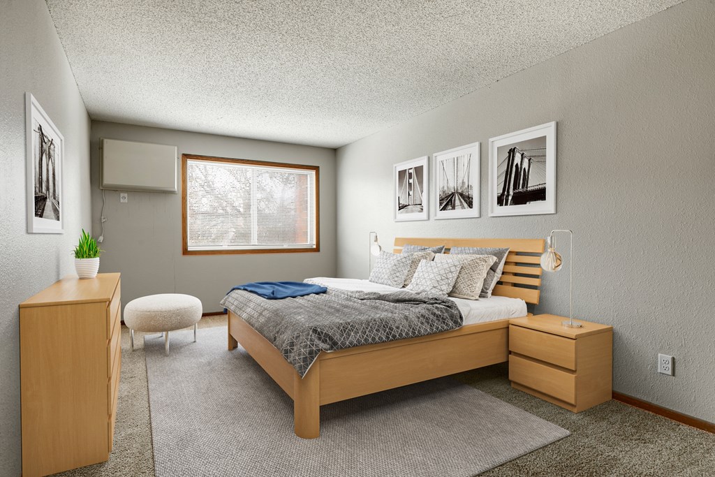 a bedroom with a bed and a dresser  at Park Pointe, Minnesota, 55426