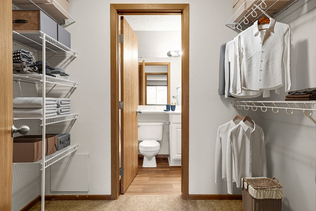 a small bathroom with a toilet and walk in closet  at Park Pointe, St. Louis Park, Minnesota