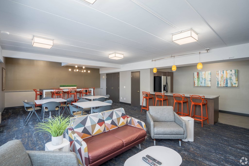 a living room with tables and chairs and a couch at Park Pointe, St. Louis Park