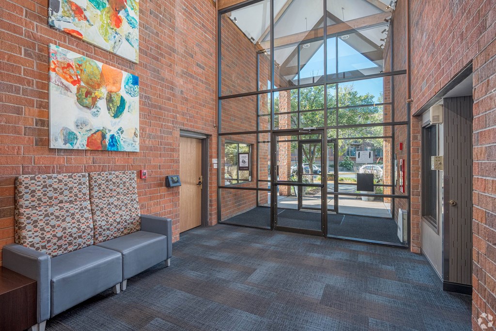 a lobby with a couch and a glass door at Park Pointe, Minnesota, 55426