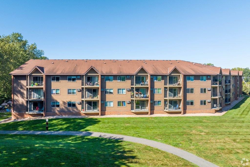 a large building with a green lawn in front of it at Park Pointe, St. Louis Park, MN, 55426