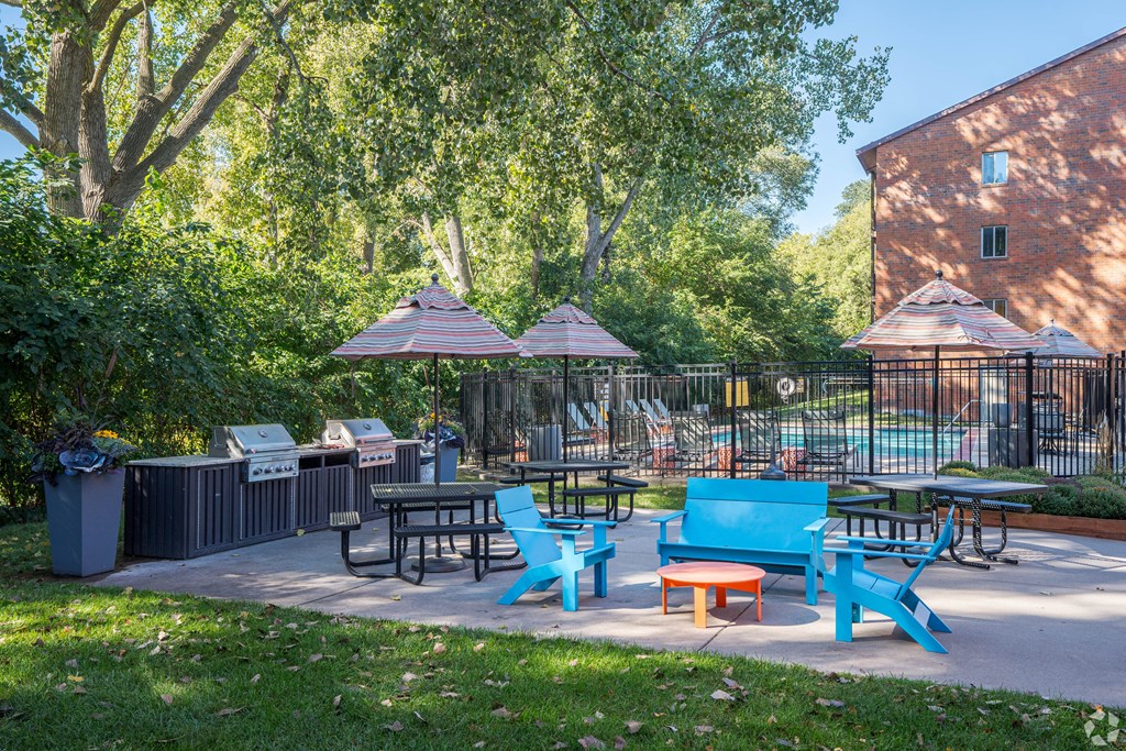 a patio with tables and chairs and umbrellas at Park Pointe, Minnesota