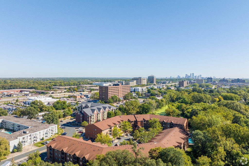 an aerial view of a city with buildings and trees at Park Pointe, St. Louis Park