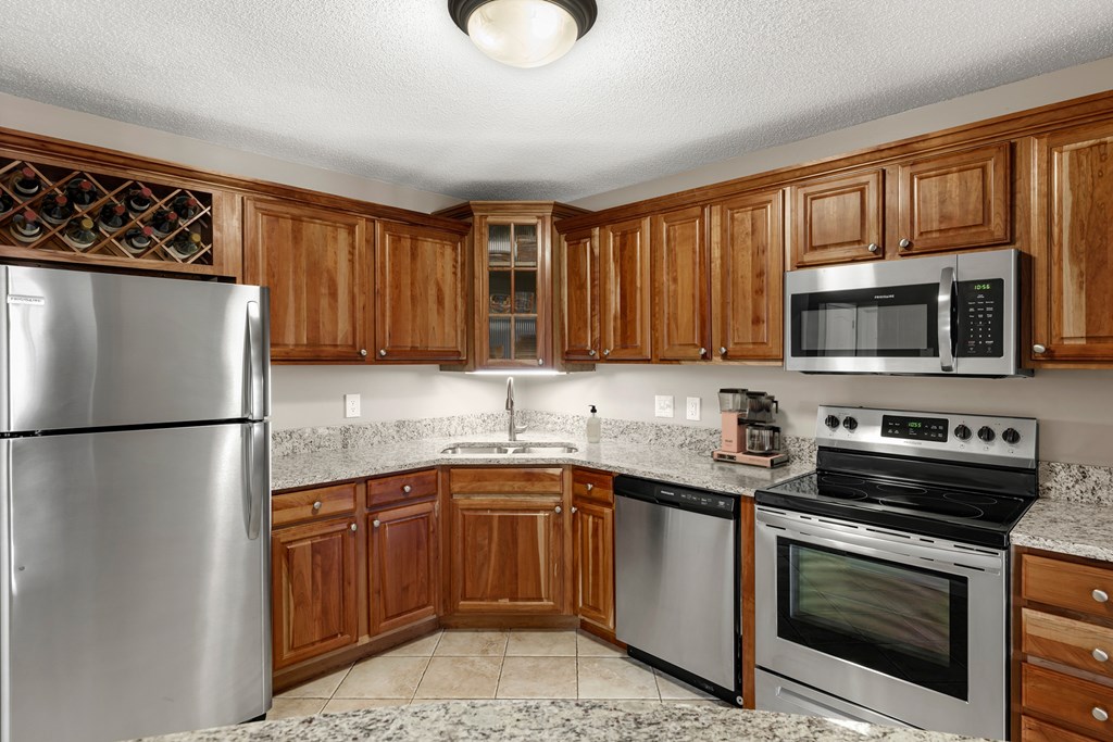Kitchen with stainless steel appliances and quartz countertops at The Riverwood in Lilydale, MN 55118