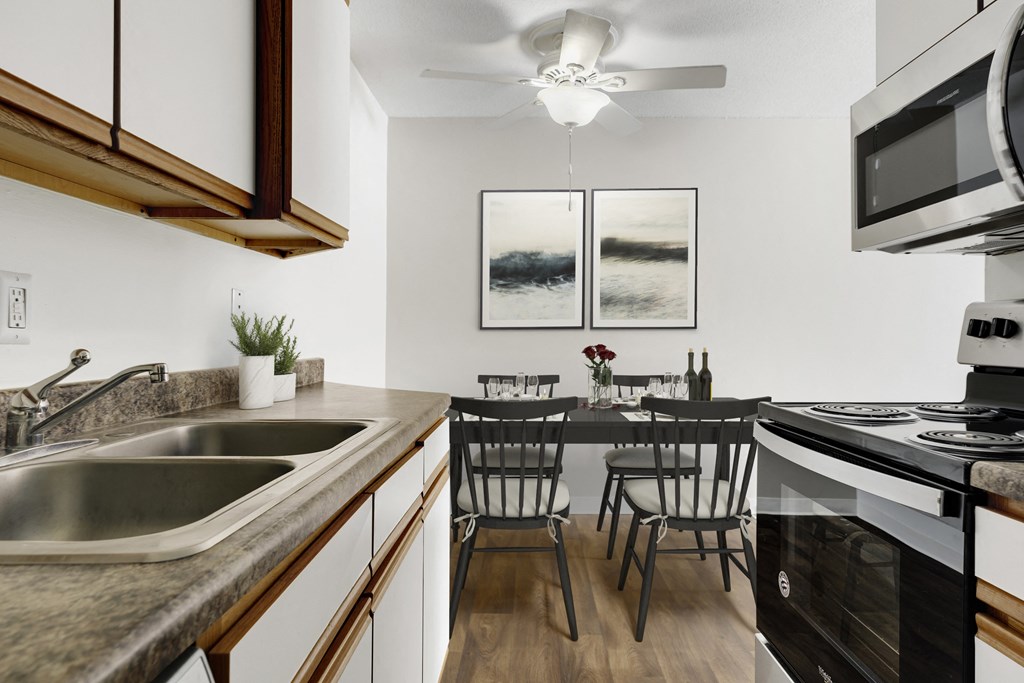 an open kitchen and dining room with a table and chairs