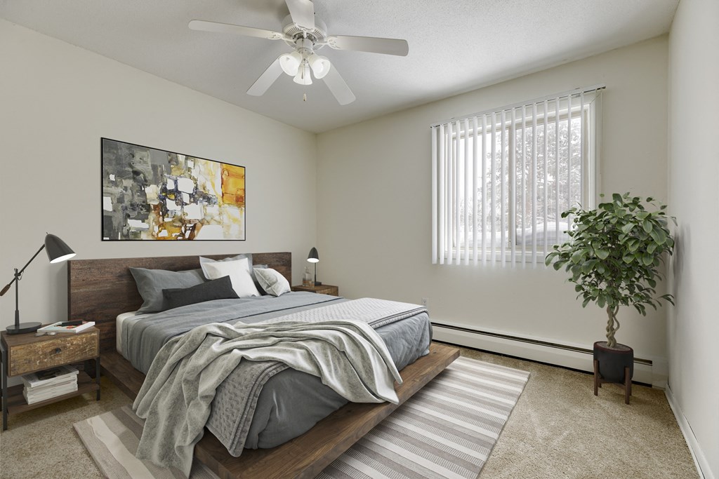 a bedroom with a large bed and a ceiling fan