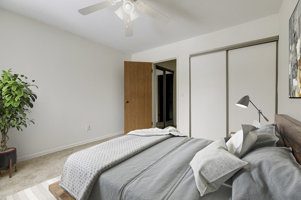 a bedroom with a large bed and a ceiling fan