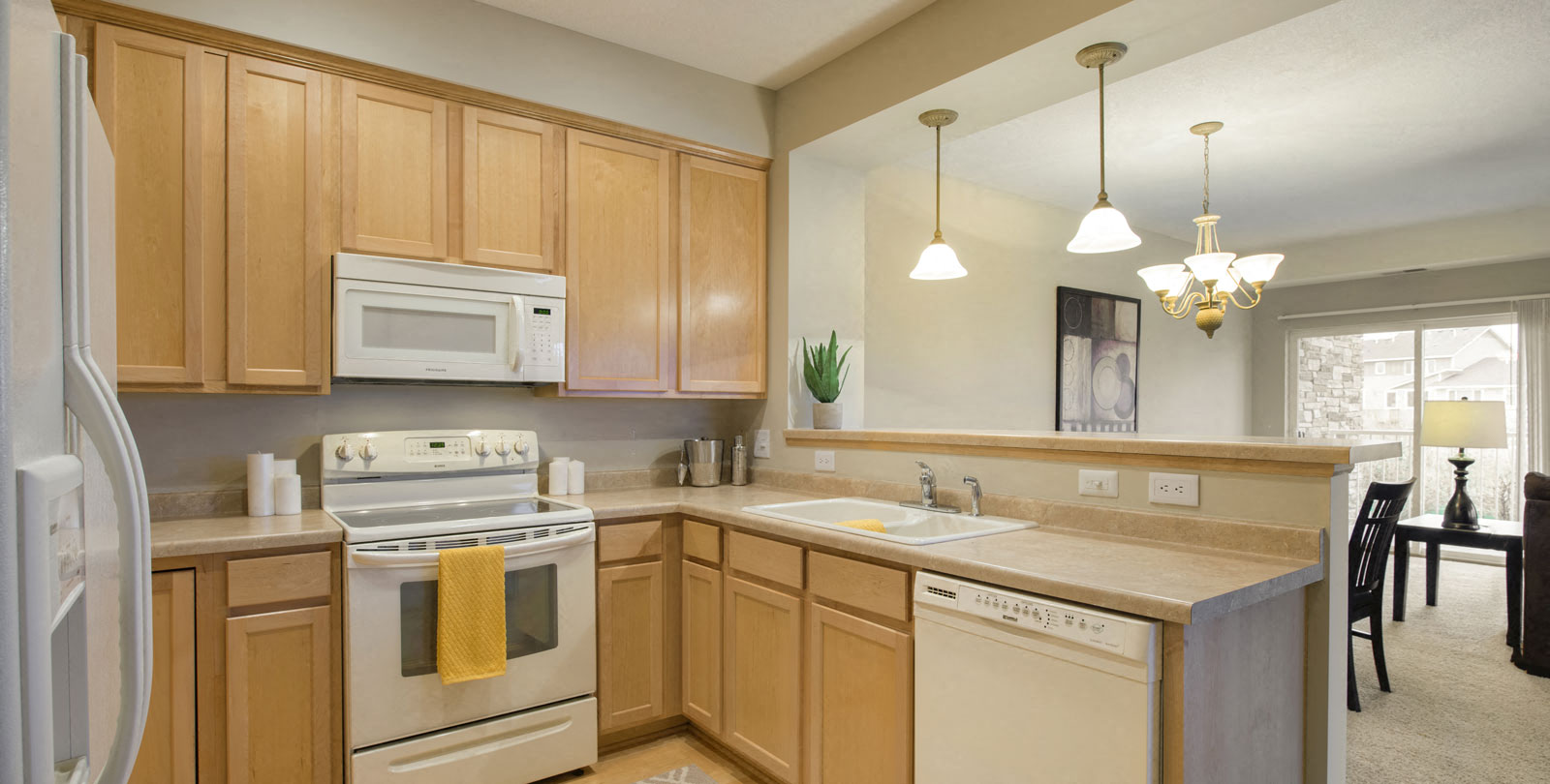 A kitchen with wooden cabinets and a white stove top oven.