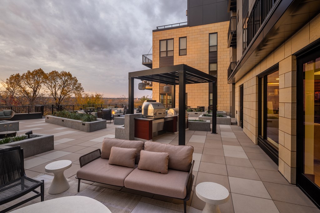 A patio with a couch and a table with a glass top.at Lilia, Lilydale, Minnesota