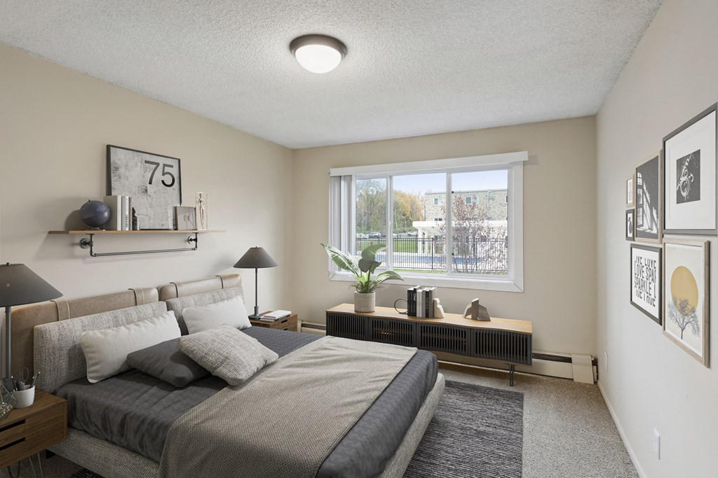 an empty bedroom with a large bed and a window