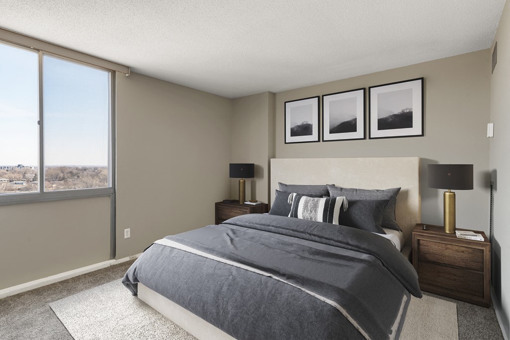 a bedroom with a large window and a large bed at The Edina Towers, Edina, MN