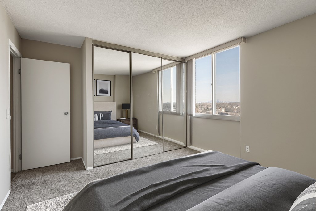 a bedroom with a bed and a large window at The Edina Towers, Edina, Minnesota