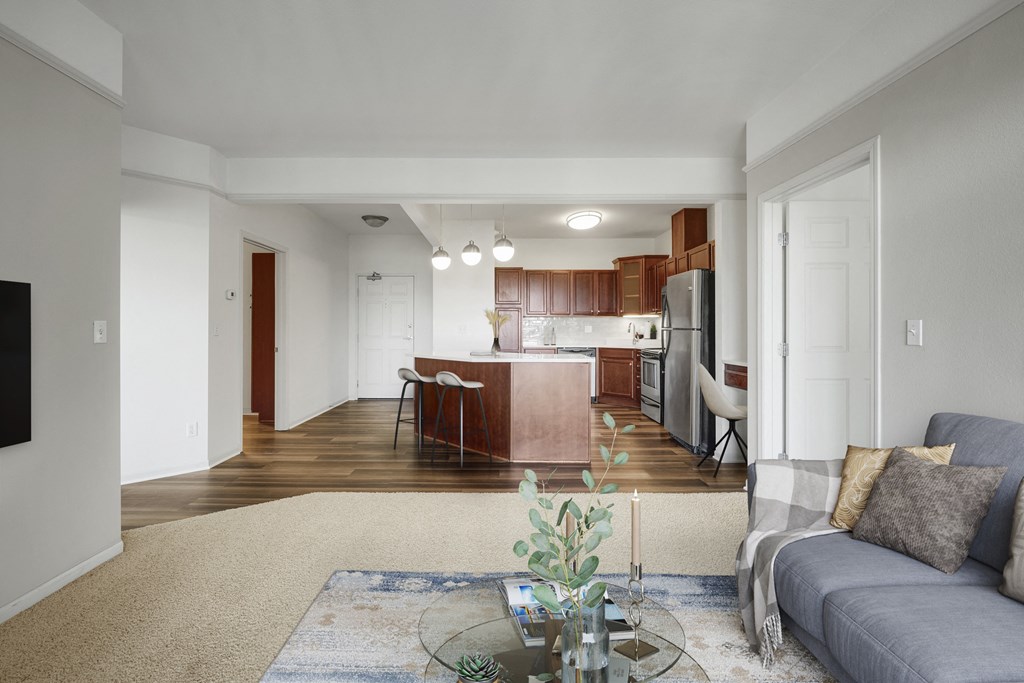 a living room and kitchen with a couch and a table
