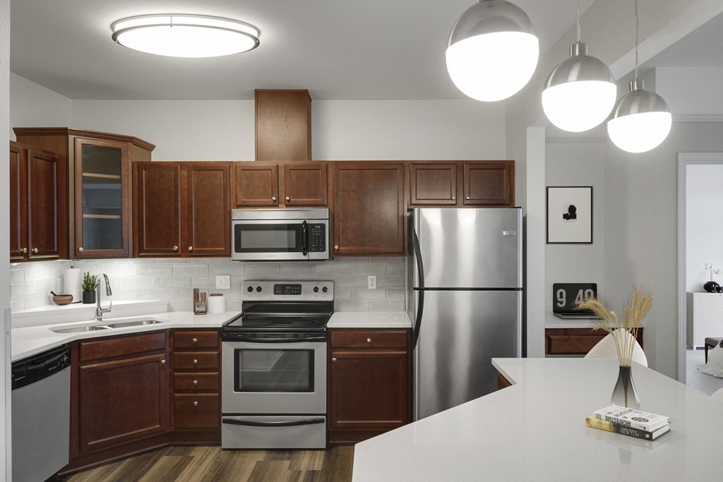 a kitchen with stainless steel appliances and wooden cabinets
