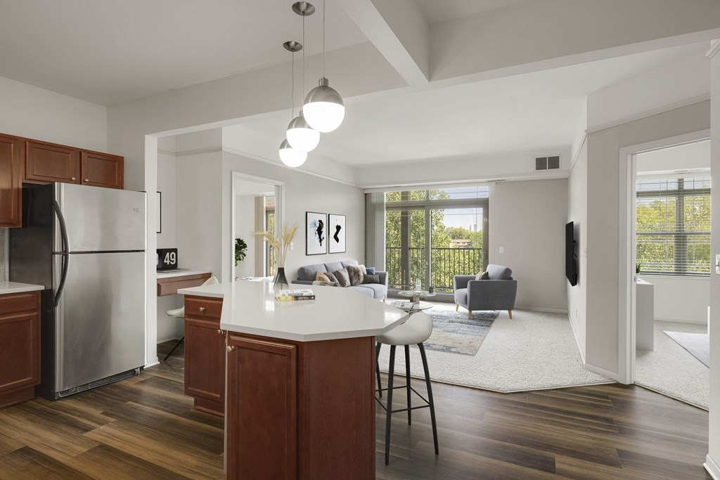 an open kitchen and living room with a white counter top