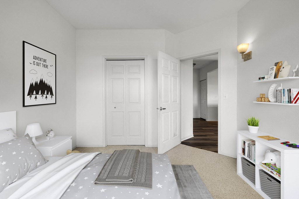 a bedroom with a bed and a closet and a door to a hallway