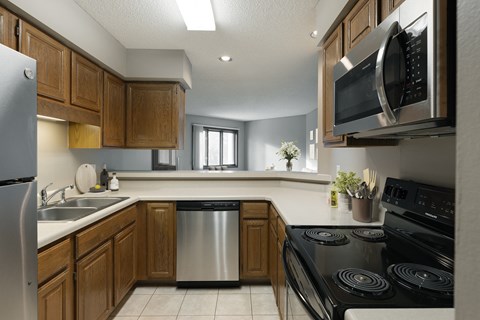 a kitchen with a stove and a sink and a microwave