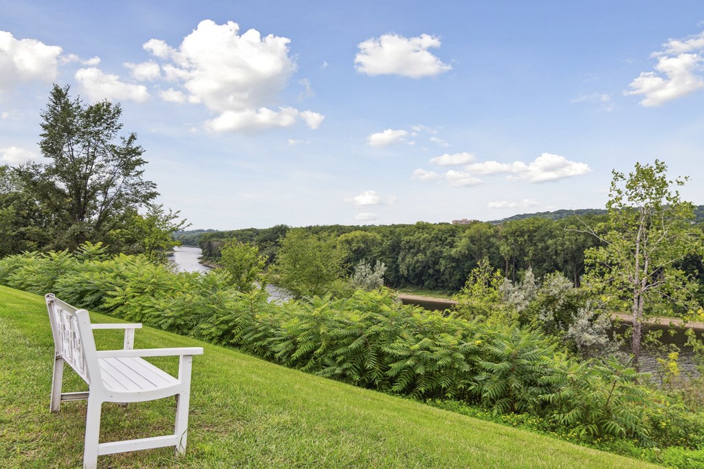 A white bench overlooking the Mississippi river at The Riverwood, Minnesota