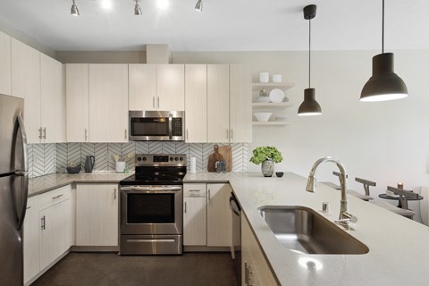 a kitchen with white cabinets and stainless steel appliances