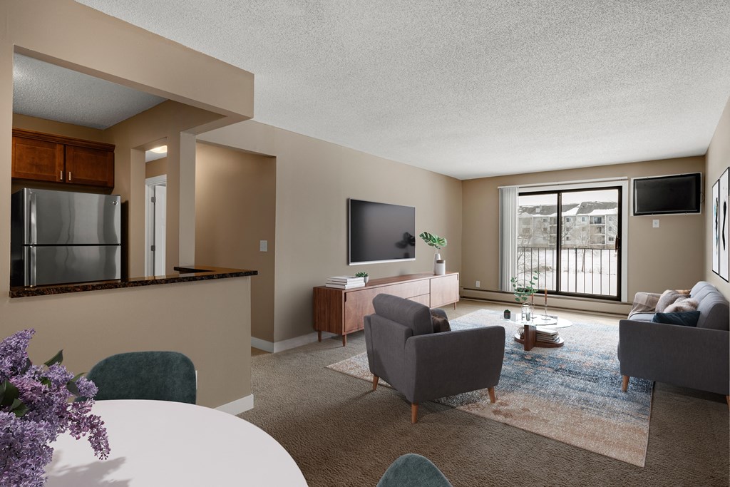 a living room with a table and chairs and a television