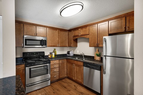 a kitchen with stainless steel appliances and wooden cabinets