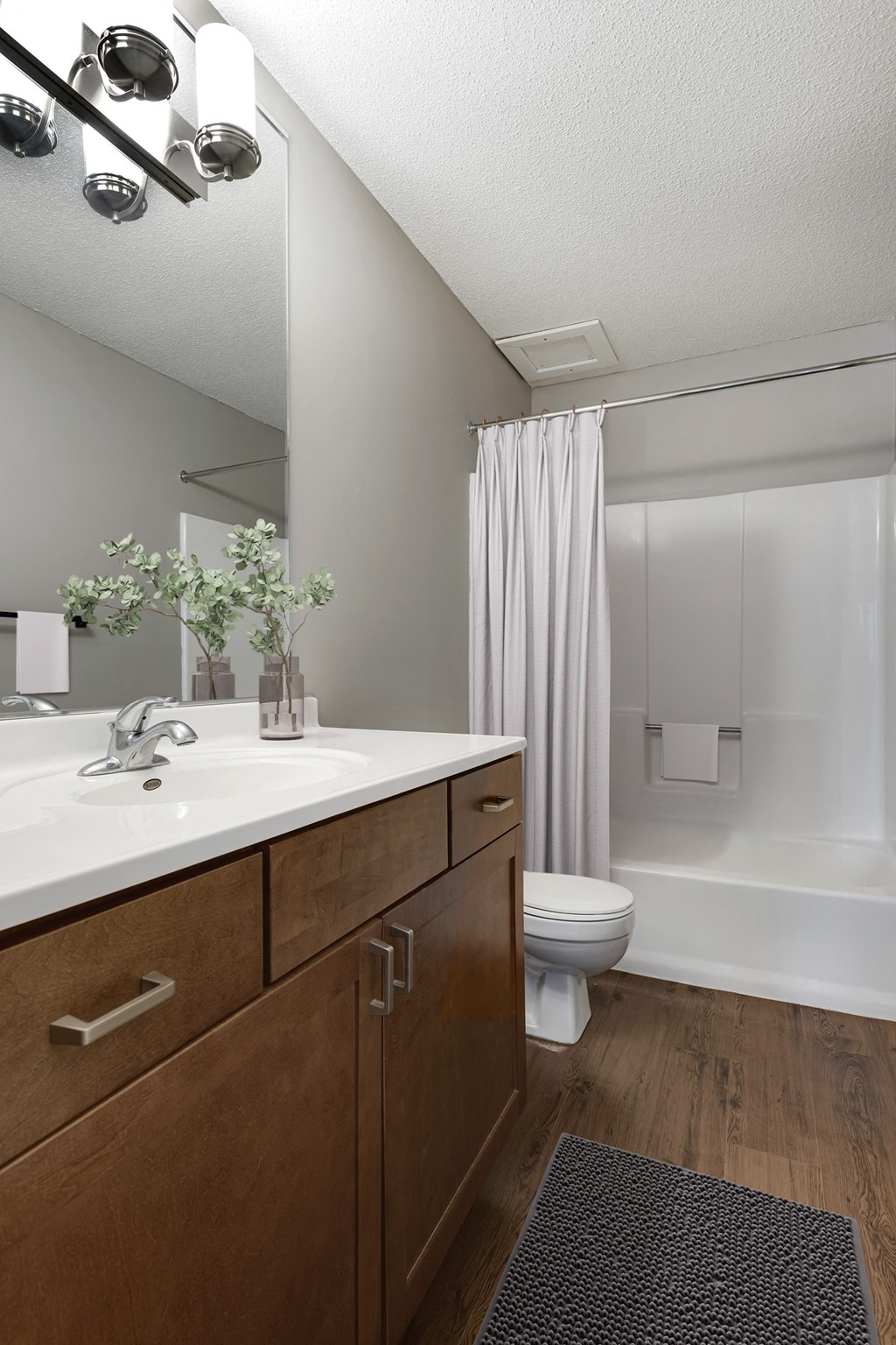 a bathroom with a sink and a toilet and a shower