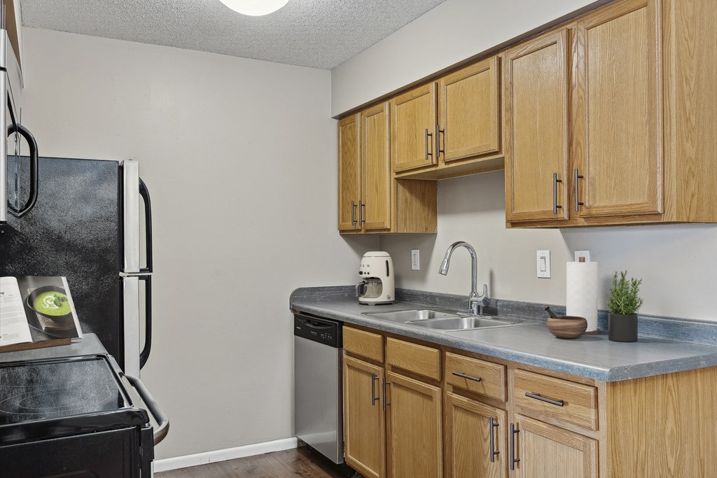 a kitchen with wooden cabinets and stainless steel appliances  at Willow Creek, Minnesota, 55441