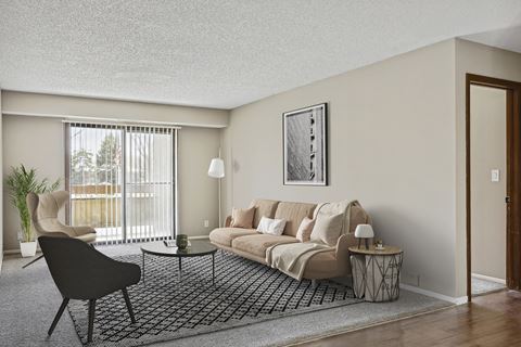 a living room with a beige couch and a black and white rug