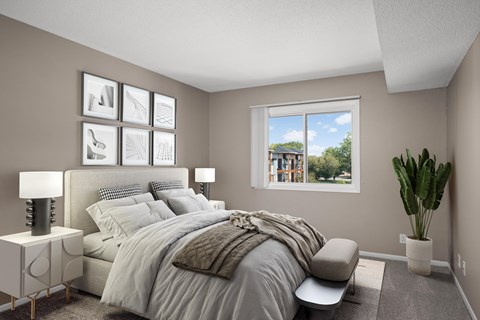 A bedroom with a large bed and a window overlooking a building.