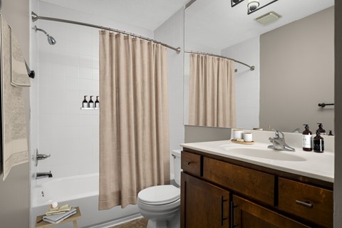 A bathroom with a toilet, sink, and shower.