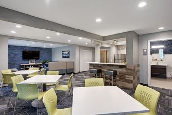 A modern dining area with a bar and a television.