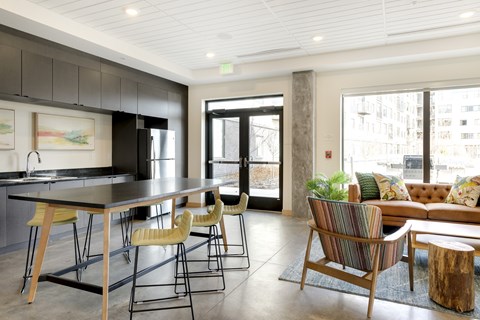 A modern kitchen with a dining table and chairs.