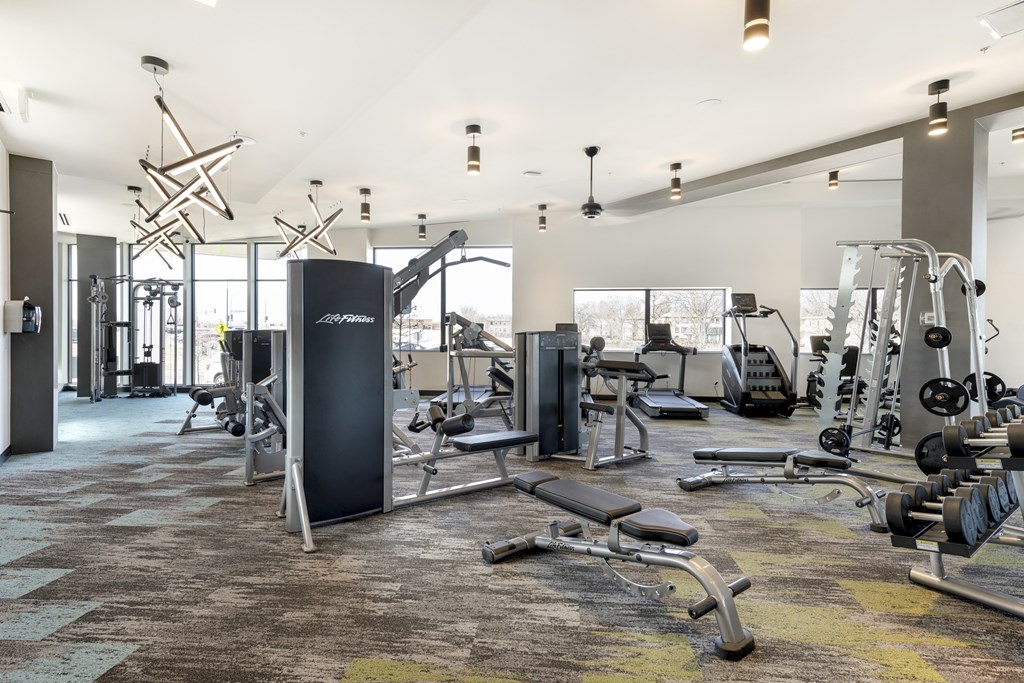 A gym with a variety of equipment including weights and cardio machines. at Zelia on Seven, St Louis Park, Minnesota