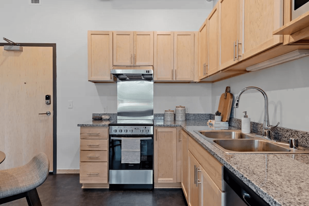 a kitchen with granite counter tops and a sink at Zelia on Seven, Minnesota, 55416
