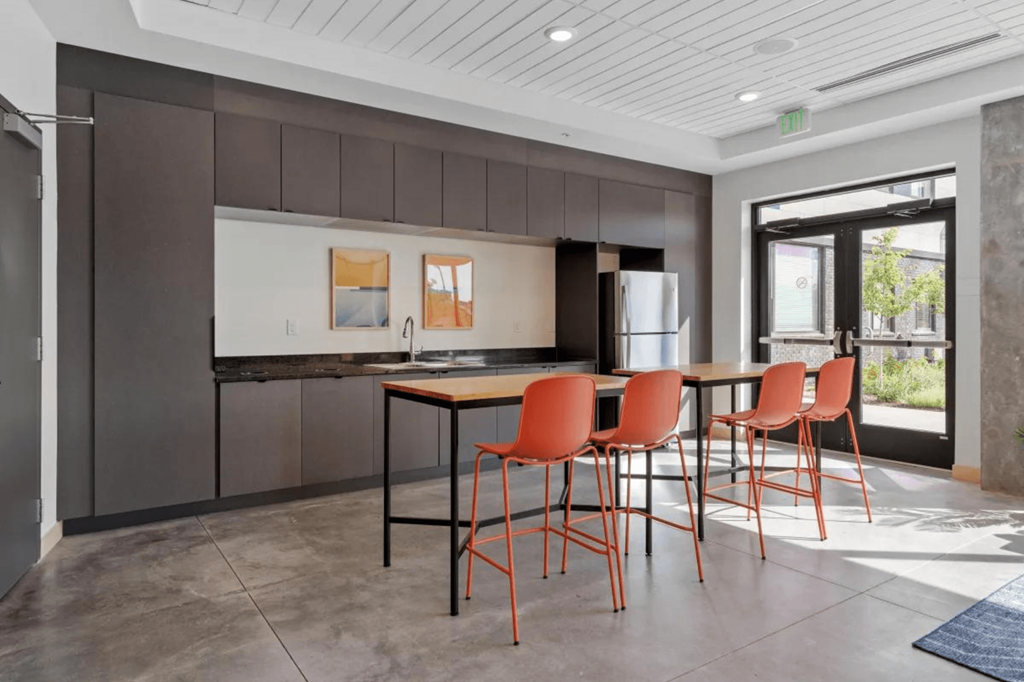 a kitchen and dining area with a table and chairs at Zelia on Seven, St Louis Park