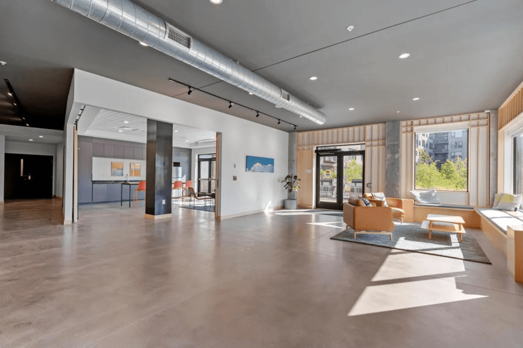 a large living room with couches and chairs and a fireplace at Zelia on Seven, St Louis Park, MN, 55416