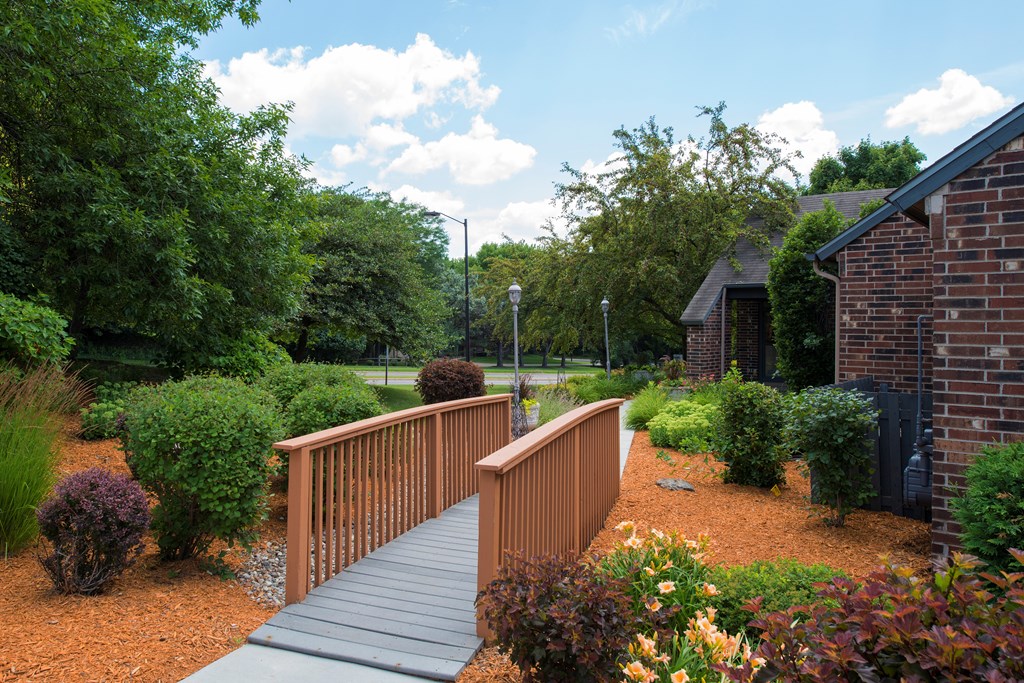 Landscaping and bridge leading to the leasing office and clubhouse at Eden Commons in Eden Prairie, MN 55344