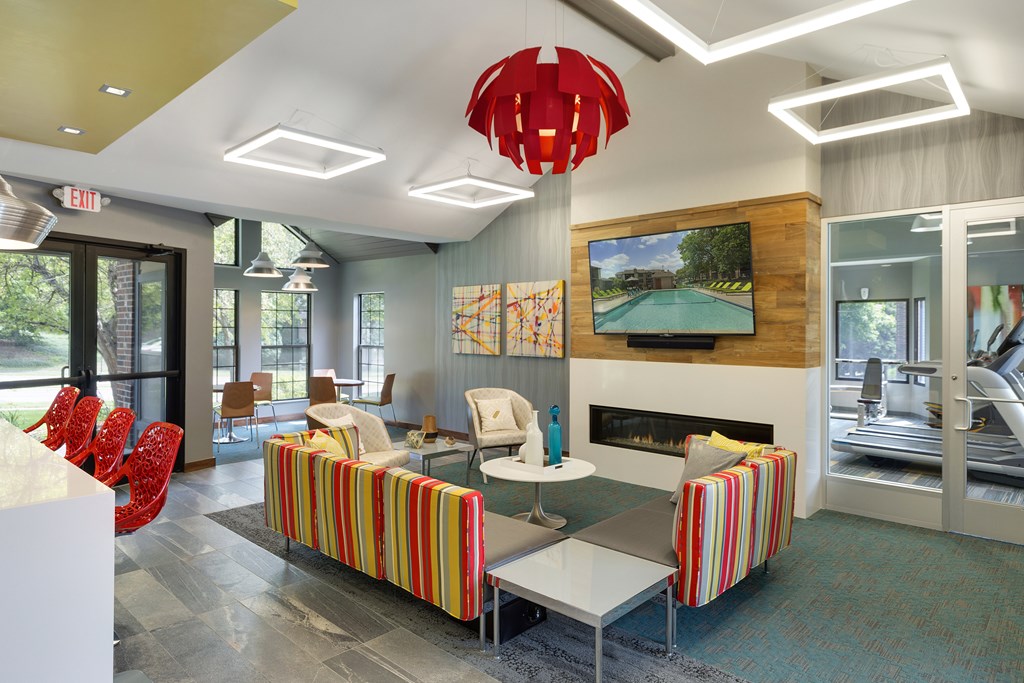 Community Room with seating, a full kitchen, and lounge chairs at Eden Commons in Eden Prairie, MN 55344