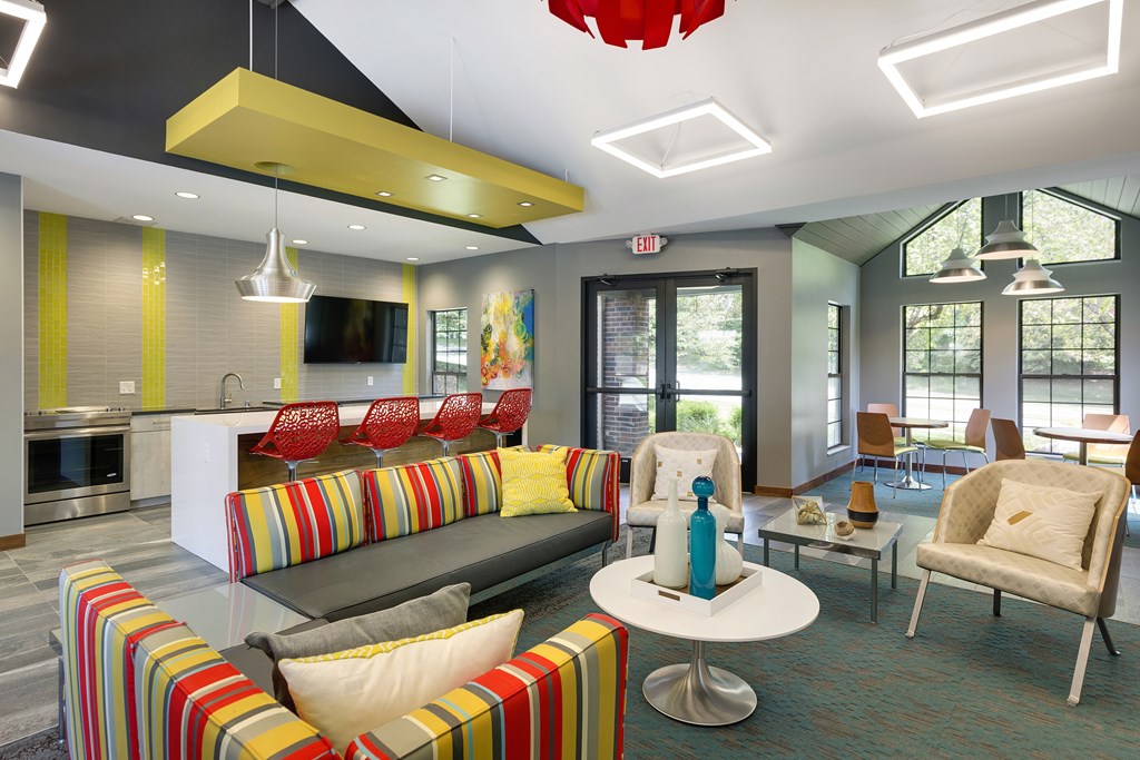 Community Room with seating, a full kitchen, and lounge chairs at Eden Commons in Eden Prairie, MN 55344