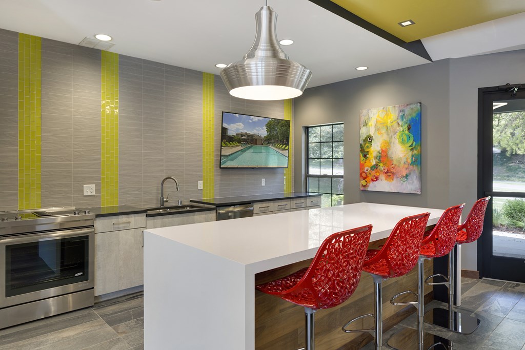 Community Room with seating, a full kitchen, and lounge chairs at Eden Commons in Eden Prairie, MN 55344