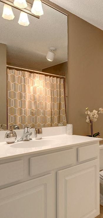 A white sink with a mirror above it.