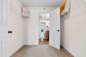 A white door is open to a bathroom.