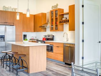 A kitchen with wooden cabinets and a white countertop.