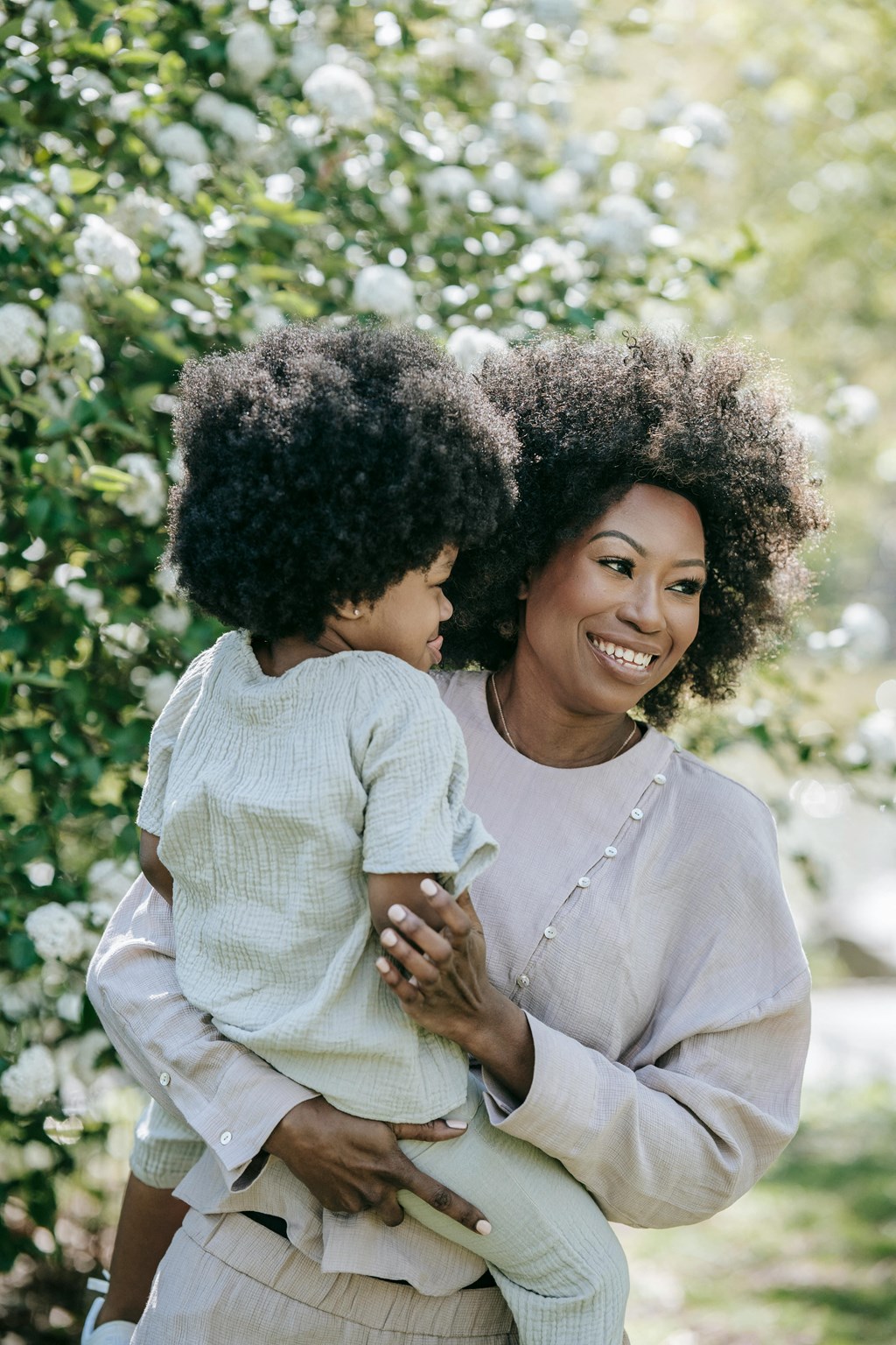 a woman holding a small child in her arms
